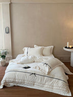 Romantic cotton satin bed linen set with ruffled hem, lace trim and decorative ribbons Kalsten