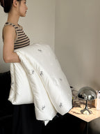 Light-warming cassette comforter with hollow fiber filling and fine tonal embroidery