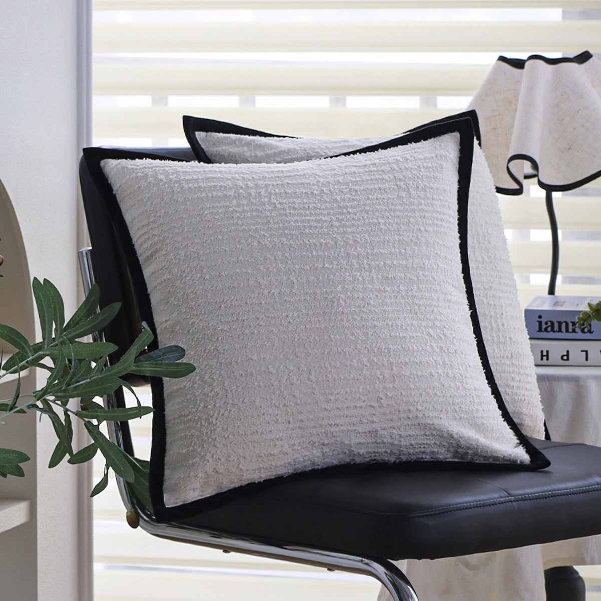 Square cushion cover with subtle herringbone texture and surrounding piping seam Kalsten