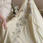 Elegant bedding set made of cotton satin with floral embroidered border and decorative roll cushion Kalsten