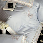 Satin bedding set with embroidered butterfly motif and silk-matte finish
