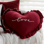 Heart-shaped decorative pillow with ruffled trim and embroidered inscription Kalsten