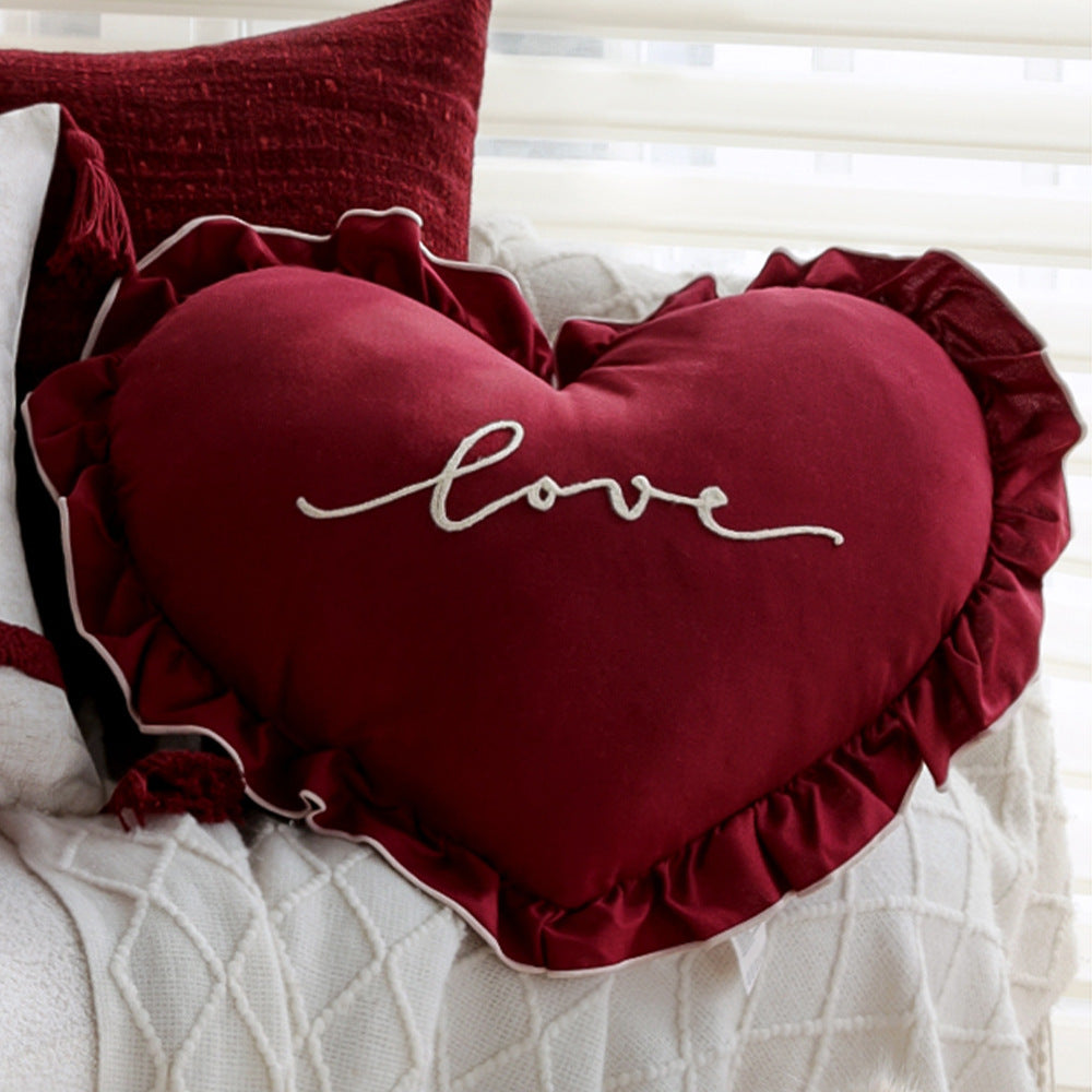 Heart-shaped decorative pillow with ruffled trim and embroidered inscription Kalsten