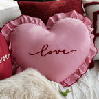 Heart-shaped decorative pillow with ruffled trim and embroidered inscription Kalsten