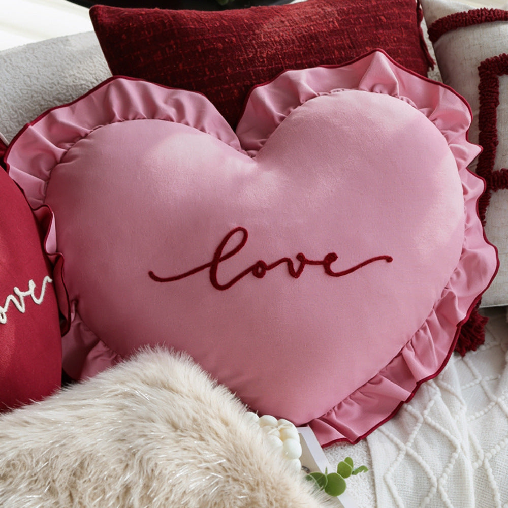 Heart-shaped decorative pillow with ruffled trim and embroidered inscription Kalsten
